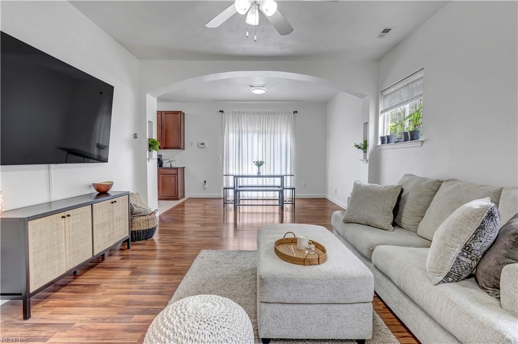 living room featuring ceiling fan and wood-type flooring