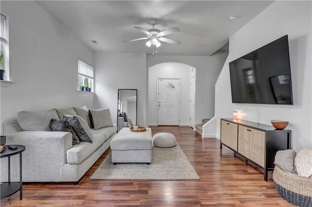 living room featuring ceiling fan and dark hardwood / wood-style flooring