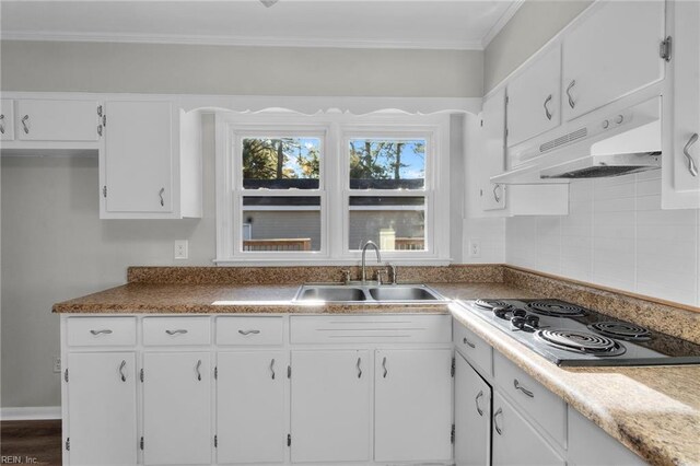 kitchen featuring dark wood-type flooring, white cabinets, stainless steel cooktop, crown molding, and sink