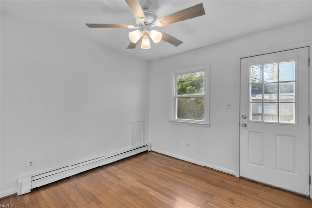 empty room with ceiling fan, light hardwood / wood-style flooring, and a baseboard radiator