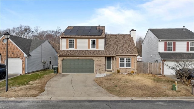 view of front of house featuring solar panels, a garage, and central AC