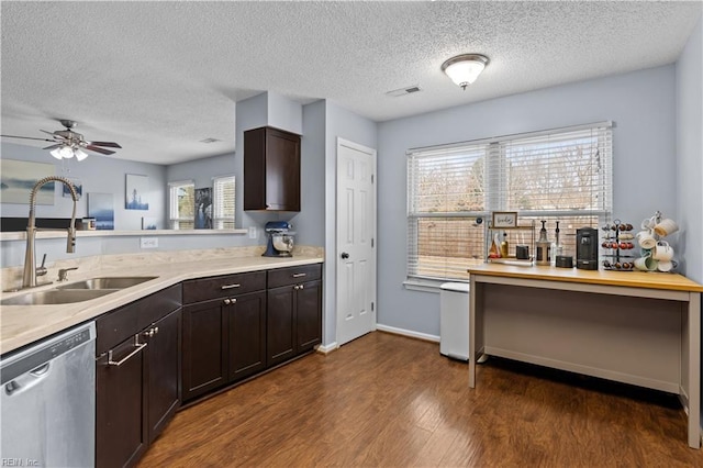 kitchen featuring stainless steel dishwasher, dark brown cabinets, ceiling fan, sink, and dark hardwood / wood-style floors