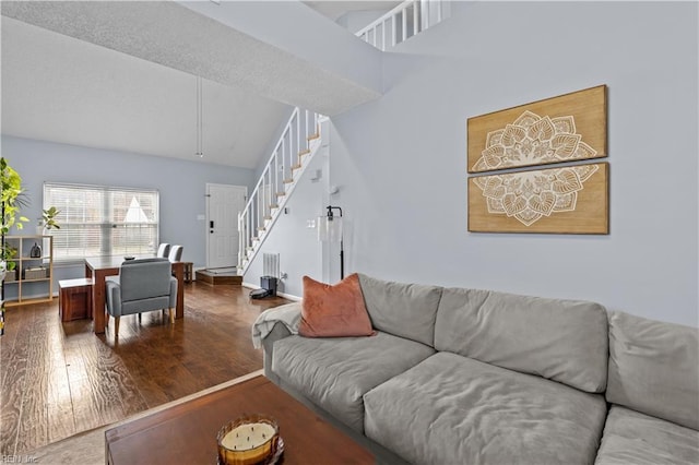 living room with hardwood / wood-style floors and lofted ceiling