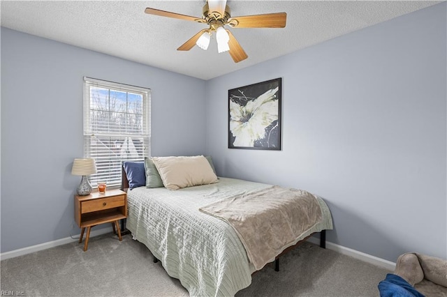 bedroom featuring ceiling fan, carpet floors, and a textured ceiling