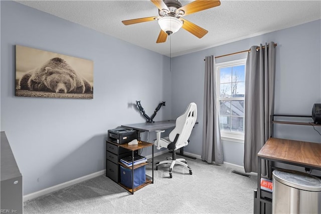 office area with carpet flooring, ceiling fan, and a textured ceiling