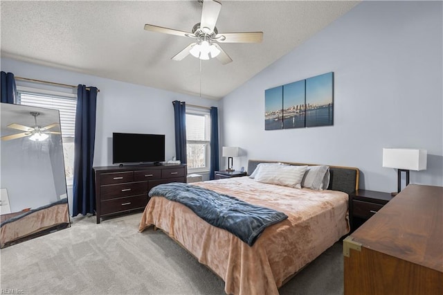 carpeted bedroom with ceiling fan, a textured ceiling, and vaulted ceiling