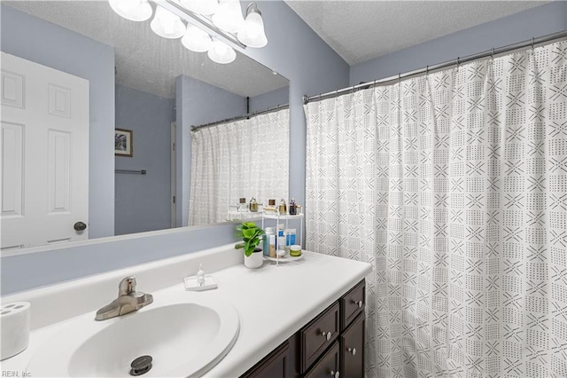 bathroom with vanity, a textured ceiling, and a shower with shower curtain