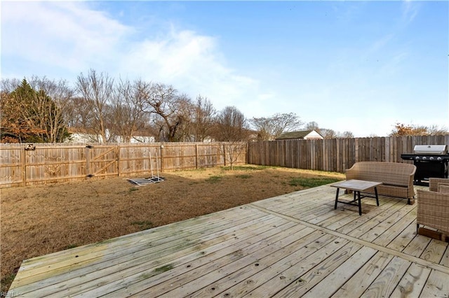 wooden deck with a grill and a yard