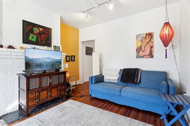 living room with track lighting and dark wood-type flooring