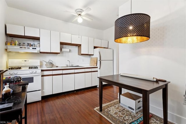 kitchen with white appliances, sink, white cabinets, dark hardwood / wood-style floors, and range hood