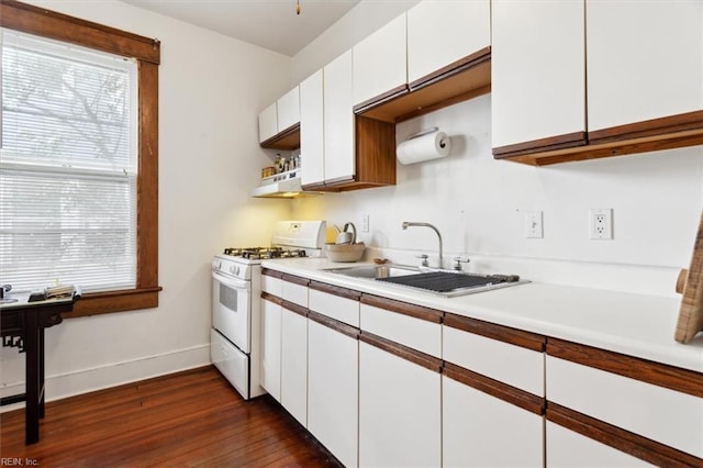 kitchen featuring white cabinetry, gas range gas stove, sink, and dark wood-type flooring