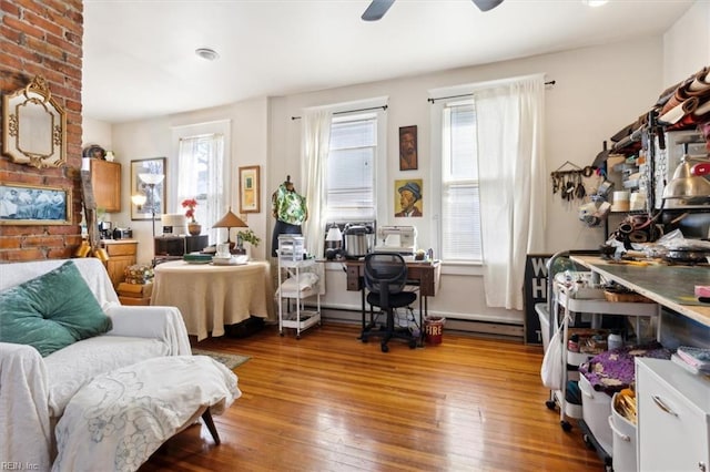 living area featuring hardwood / wood-style flooring, plenty of natural light, and ceiling fan