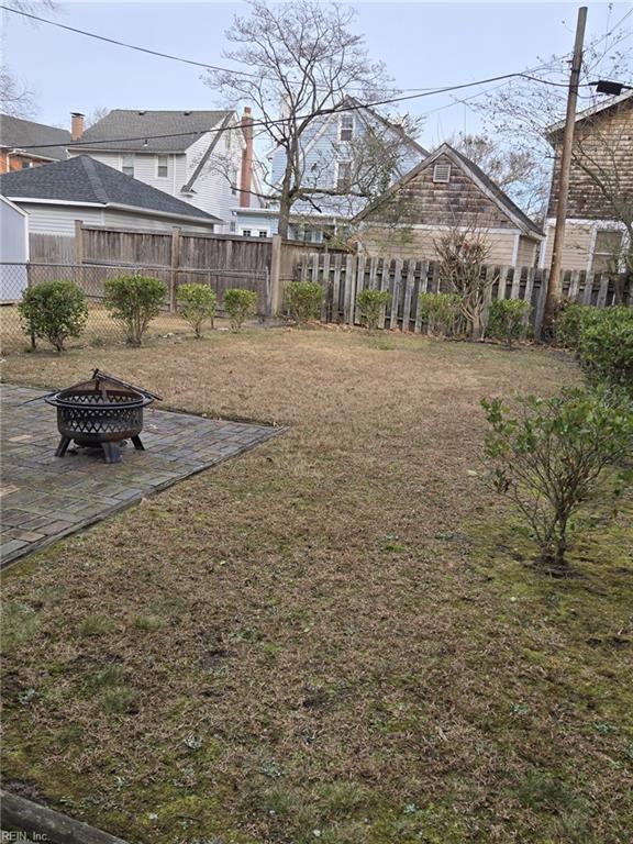 view of yard with an outdoor fire pit and a patio