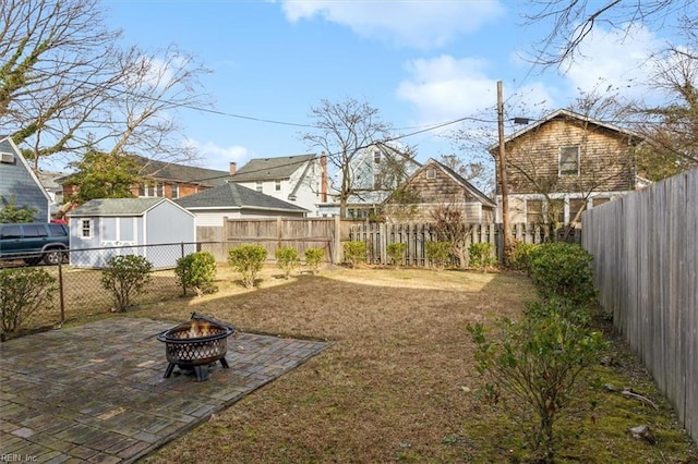 view of yard featuring a patio and a fire pit