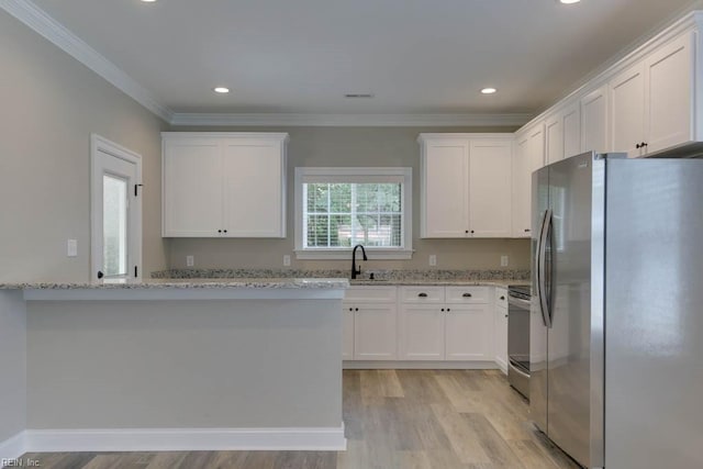 kitchen featuring white cabinets, sink, light hardwood / wood-style flooring, light stone countertops, and stainless steel appliances