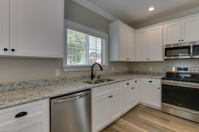 kitchen with white cabinets, light stone countertops, sink, and appliances with stainless steel finishes