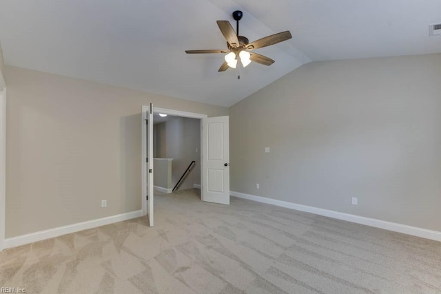 unfurnished bedroom with ceiling fan, light colored carpet, and vaulted ceiling