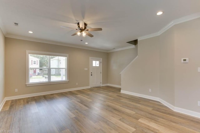 entryway with ceiling fan, crown molding, and light hardwood / wood-style flooring