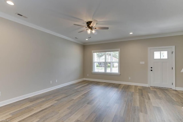 foyer with light wood-type flooring, ceiling fan, and crown molding