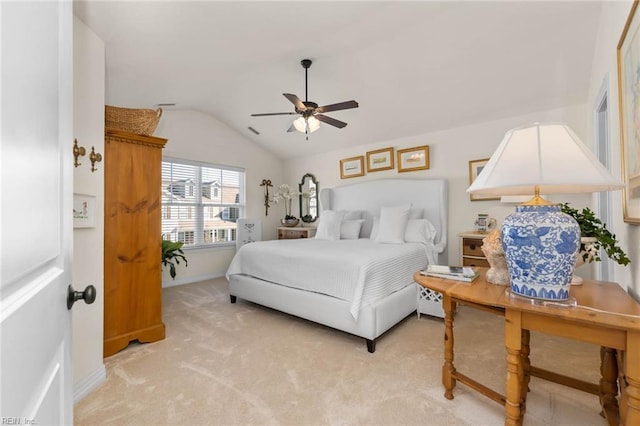 carpeted bedroom featuring ceiling fan and vaulted ceiling