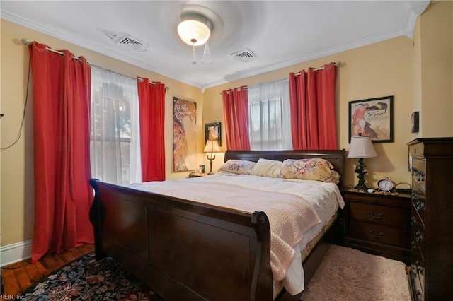 bedroom featuring hardwood / wood-style floors and crown molding