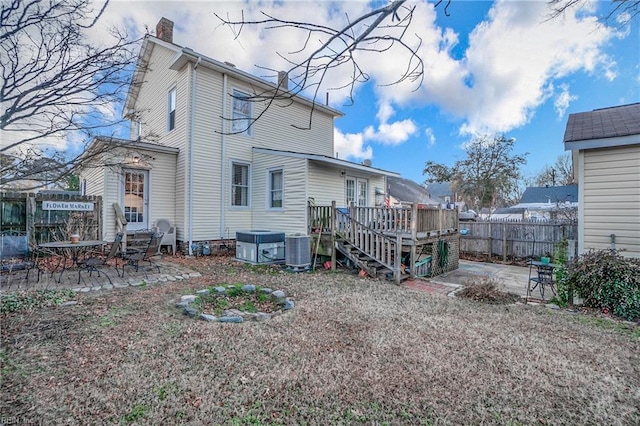 rear view of house featuring a deck, central AC unit, and a patio area