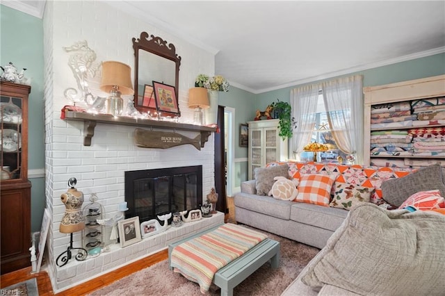 living room featuring crown molding, hardwood / wood-style flooring, and a brick fireplace