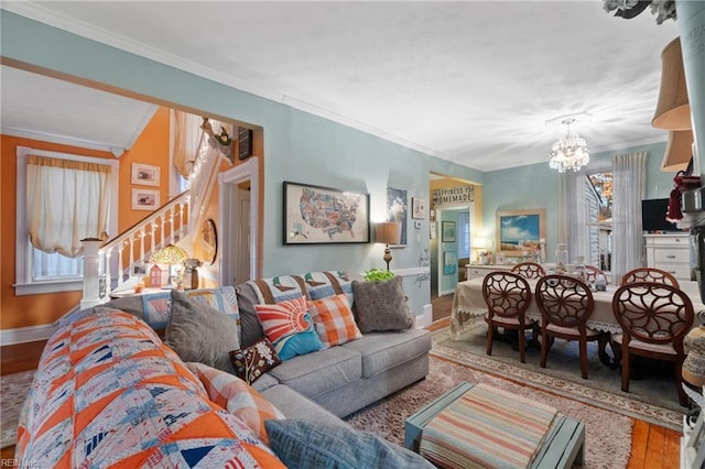 living room featuring a notable chandelier, wood-type flooring, and crown molding