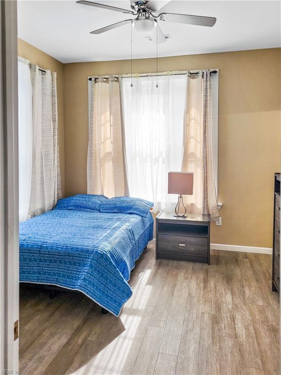 bedroom with light hardwood / wood-style flooring and ceiling fan