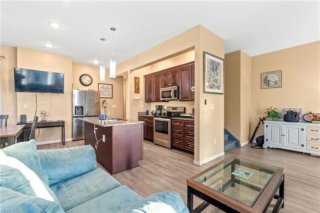 living room with sink and light wood-type flooring