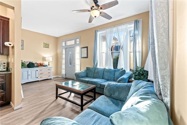 living room featuring light hardwood / wood-style floors and ceiling fan