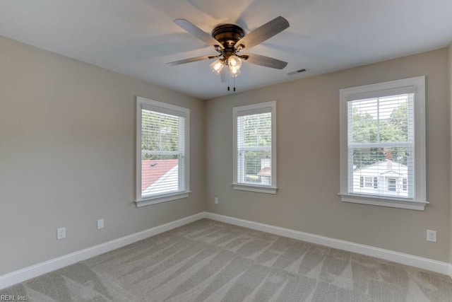 carpeted spare room featuring ceiling fan