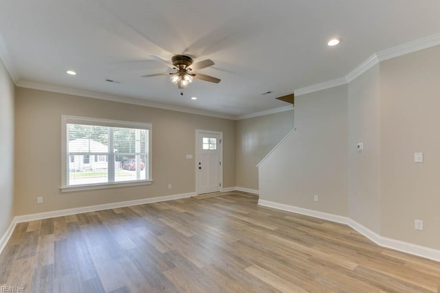 interior space featuring ceiling fan, light wood-type flooring, and ornamental molding