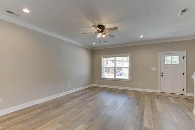 entrance foyer featuring ceiling fan, a healthy amount of sunlight, and ornamental molding