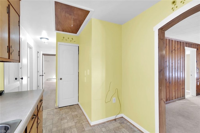 interior space featuring sink and wooden walls