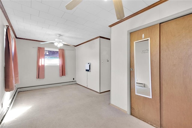 spare room with crown molding, ceiling fan, and light colored carpet