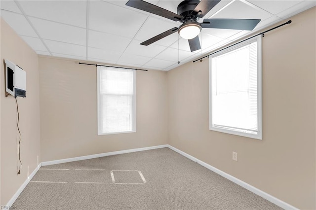 unfurnished room with carpet floors, ceiling fan, and a paneled ceiling