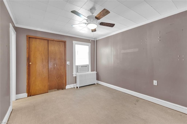 unfurnished bedroom featuring radiator, ceiling fan, a closet, and light colored carpet