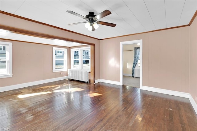 empty room featuring radiator heating unit, dark hardwood / wood-style floors, and a healthy amount of sunlight