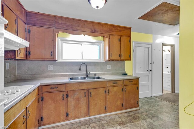 kitchen featuring tasteful backsplash, sink, and white cooktop