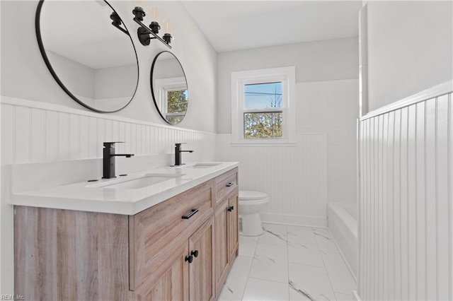 bathroom featuring vanity and toilet