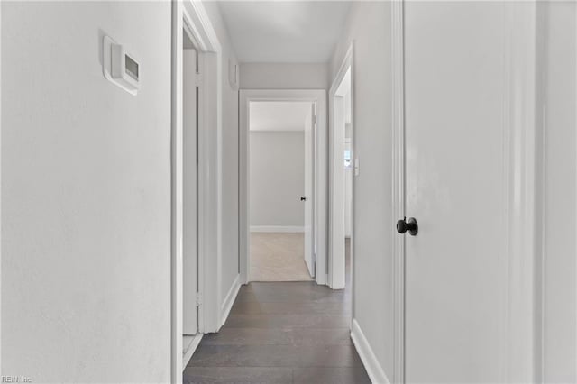 corridor with dark wood-type flooring