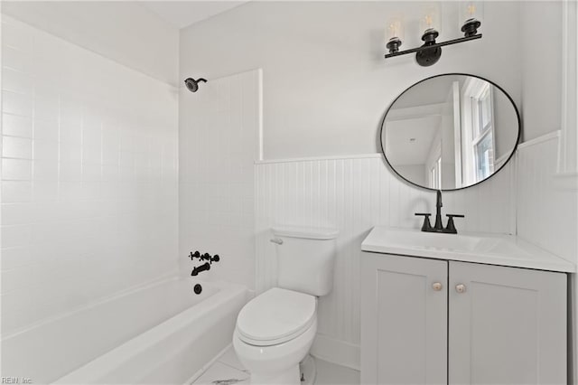 full bathroom featuring vanity, tiled shower / bath combo, and toilet