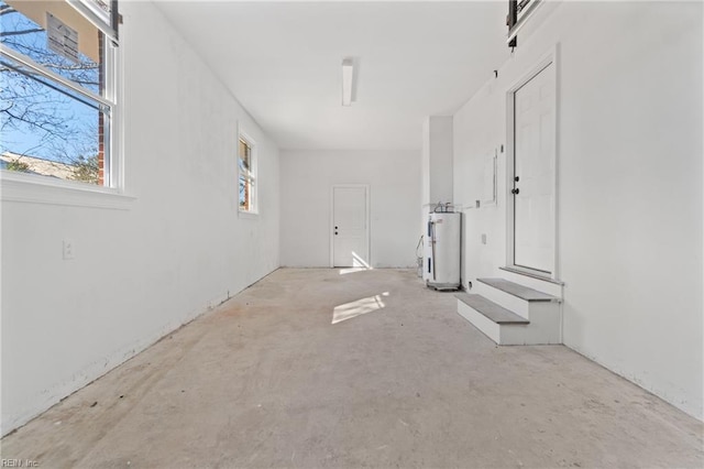 interior space featuring a barn door and electric water heater