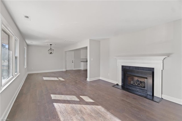 unfurnished living room with dark wood-type flooring