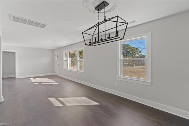 unfurnished dining area with dark wood-type flooring