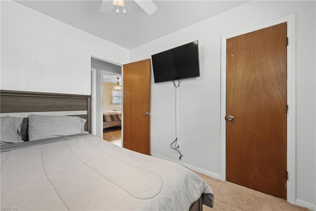 bedroom with ceiling fan and light carpet