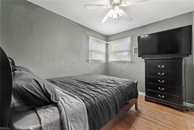 bedroom with ceiling fan and hardwood / wood-style flooring