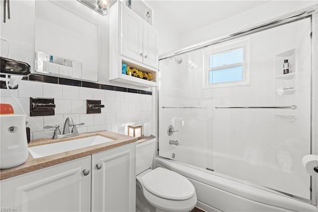 full bathroom featuring backsplash, vanity, tile walls, enclosed tub / shower combo, and toilet