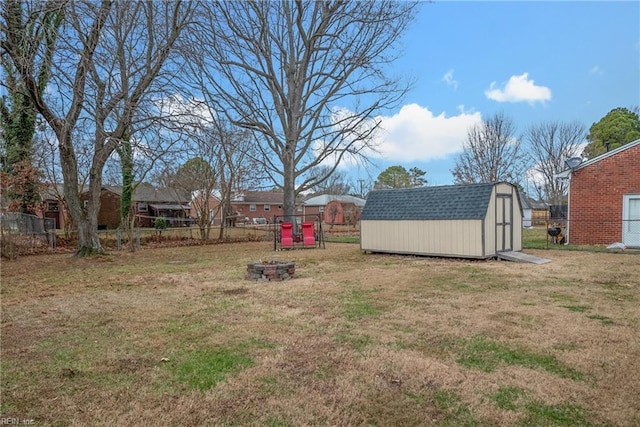 view of yard with a fire pit and a storage unit